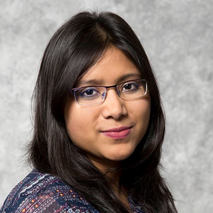 Karishma Kibria, Water Resources Engineer, wearing business casual attire in front of a light grey background.