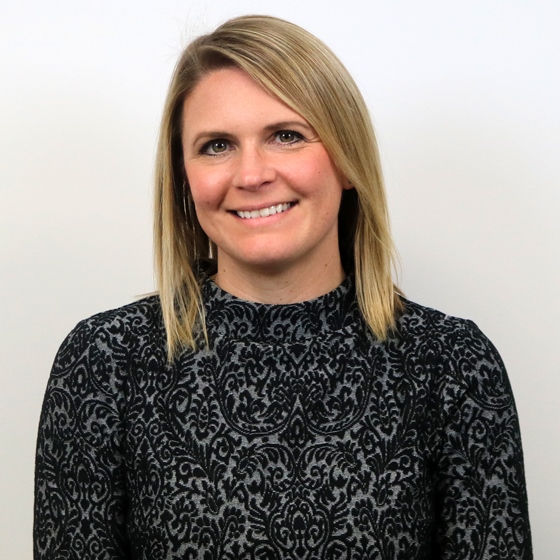 Audrey Signorelli, Senior NPDES Program Specialist, Permitting & Regulatory Support Practice Area Leader, stands in front of a light-colored wall in business attire.